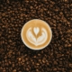 Glass of iced coffee topped with creamy cold foam on a cafe table