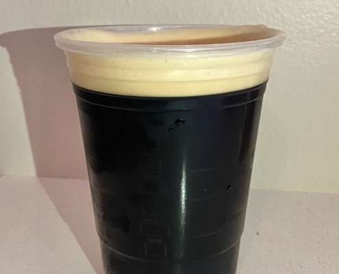 Realistic iced coffee topped with a creamy layer of cold foam